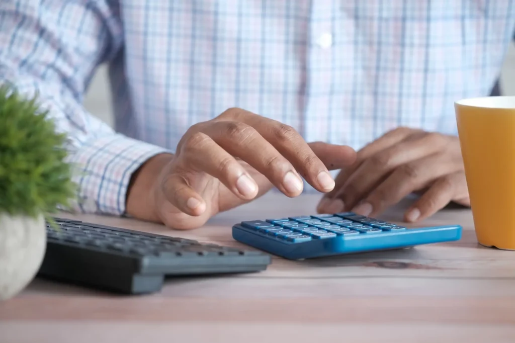 Close up of man hand using a calculator to determine CPI.